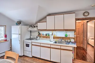 a kitchen with a white refrigerator and a sink at New York Vacation Rental with Smart TVs and Cable in Saugerties