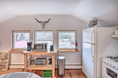 a kitchen with a refrigerator and a table with appliances at New York Vacation Rental with Smart TVs and Cable in Saugerties