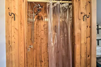 a wooden wall with a shower curtain on it at New York Vacation Rental with Smart TVs and Cable in Saugerties