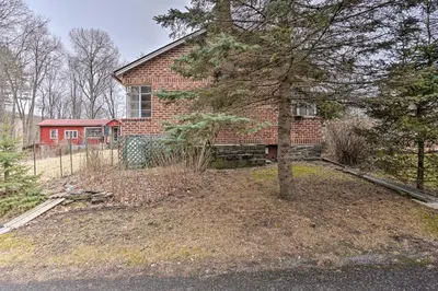 a brick house with a tree in front of it at New York Vacation Rental with Smart TVs and Cable in Saugerties