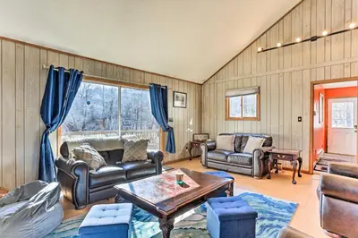 a living room with a couch and a table at Game Room, Fire Pit Family-Friendly Poconos Haven in East Stroudsburg
