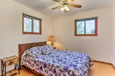 a bedroom with a bed and a ceiling fan at Game Room, Fire Pit Family-Friendly Poconos Haven in East Stroudsburg