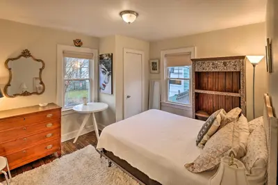 a bedroom with a bed and a dresser and a mirror at Bridgeport Vacation Rental - Walk to Beach! in Bridgeport