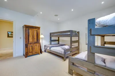 a room with three bunk beds and a hallway at Luxury Vacation Rental in the Berkshires! in Williamstown