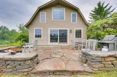 a home with a stone patio and a house at Vacation Rental Home in the Berkshires! in Williamstown
