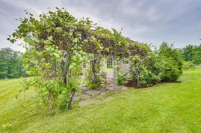 an ivy covered house in the middle of a field at Vacation Rental Home in the Berkshires! in Williamstown