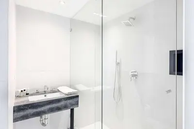 a bathroom with a shower and a sink at Nova Hotel Brooklyn in Brooklyn