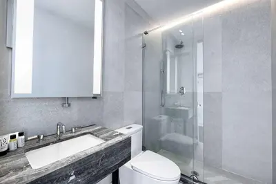 a bathroom with a toilet and a sink and a shower at Nova Hotel Brooklyn in Brooklyn