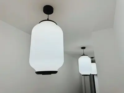 a pair of lights hanging from a wall at Nova Hotel Brooklyn in Brooklyn