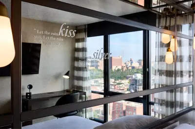 a room with a window with a view of a city at Renaissance New York Harlem Hotel in New York