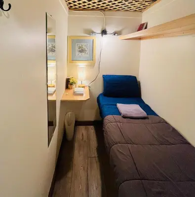 a small room with two beds and a desk at New York Spirit Retreats HOSTEL in New York