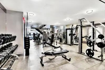 a gym with several treadmills and weights at Rector Place in New York