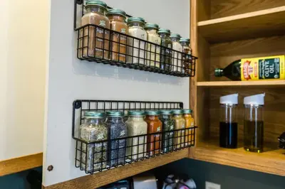 a kitchen pantry with jars on the wall at Wine Moose w Hot tub Fireplace Sauna 9min to Mt Snow in Dover