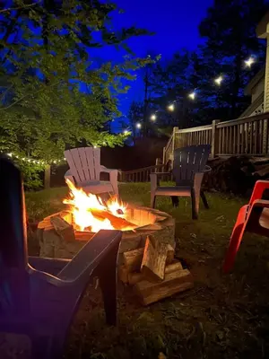 a fire pit in a yard at night at Wine Moose w Hot tub Fireplace Sauna 9min to Mt Snow in Dover
