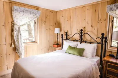 a bedroom with a white bed and a window at Wine Moose w Hot tub Fireplace Sauna 9min to Mt Snow in Dover