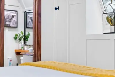 a bedroom with a bed with a yellow blanket at Maple Pine w Hot Tub Pool Table 3min to Mount Snow in Dover