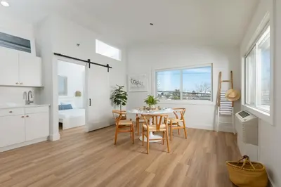 a kitchen and dining room with a table and chairs at DUNE Fairfield Beach in Fairfield