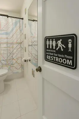 a bathroom with a toilet and a sign on the door at Blue style Room in Guesthouse in New York