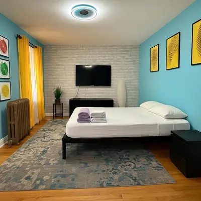 a bedroom with a bed and a flat screen tv at Blue style Room in Guesthouse in New York