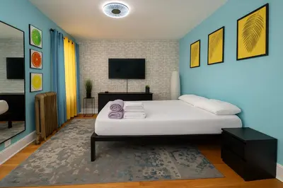 a bedroom with a white bed and a blue wall at Blue style Room in Guesthouse in New York