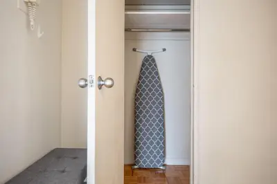 a closet with a tie hanging on a door at Midtown E 2BR w WD nr Central Park NYC-531 in New York