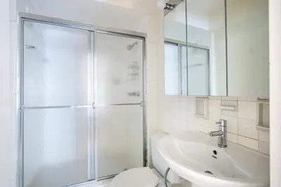 a bathroom with a shower and a toilet and a sink at Midtown E 2BR w WD nr Central Park NYC-531 in New York