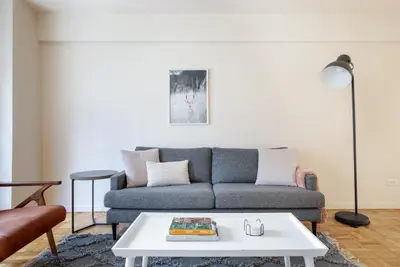 a living room with a couch and a table at Midtown E 2BR w WD nr Central Park NYC-531 in New York