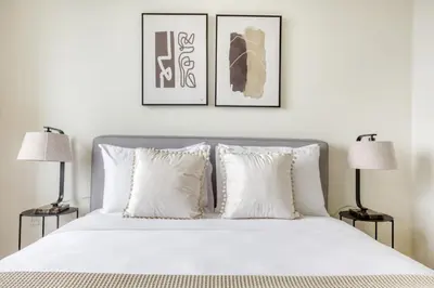 a bedroom with a white bed with two lamps at LIC 1BR w WD Elevator Doorman nr E River NYC-852 in New York