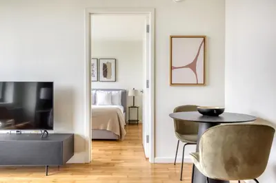 a living room with a table and a bedroom at LIC 1BR w WD Elevator Doorman nr E River NYC-852 in New York