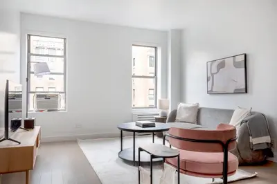 a living room with a couch and a table at UWS 2br w elevator doorman gym nr Central Park NYC-952 in New York
