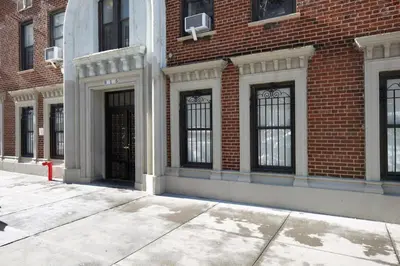 a brick building with black doors and windows at UWS 2br w elevator doorman gym nr Central Park NYC-952 in New York