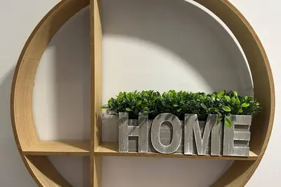 a wooden shelf with a home sign and a plant at Luxury 3Bed Private Apartment Near Manhattan in New Rochelle