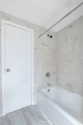 a white bathroom with a tub and a shower at Luxury 3Bed Private Apartment Near Manhattan in New Rochelle