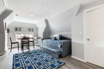 a bedroom with a bed and a dining room with a table at Luxury 3Bed Private Apartment Near Manhattan in New Rochelle