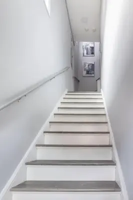a staircase in a building with white walls and white steps at Luxury 3Bed Private Apartment Near Manhattan in New Rochelle