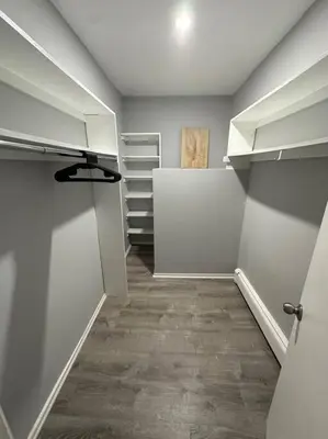 an empty closet with white cabinets and a hallway at Luxury 3Bed Private Apartment Near Manhattan in New Rochelle