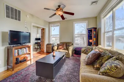 a living room with a couch and a ceiling fan at Canal-Front Waterford Apartment on Hudson River in Waterford