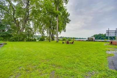 a park with trees and benches in the grass at Canal-Front Waterford Apartment on Hudson River in Waterford