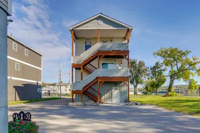 aominium building with a staircase leading up to it at Canal-Front Waterford Apartment on Hudson River in Waterford