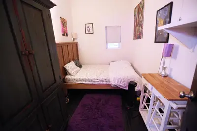 a small bedroom with a bed and a desk at Beautiful and spacious apartment in Times Square! in New York