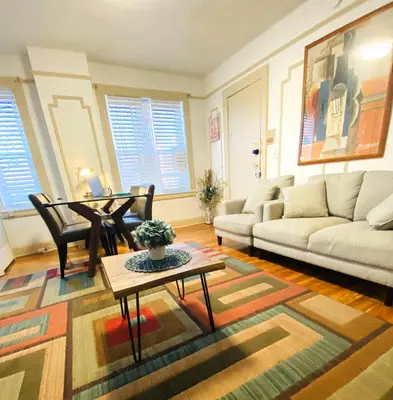 a living room with a couch and a table at NYC Cozy Private Bedroom with Free Parking & Near Subway - Business & Tourists in Van Nest