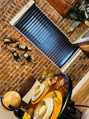 a table with a guitar on it in a kitchen at NYC Cozy Private Bedroom with Free Parking & Near Subway - Business & Tourists in Van Nest