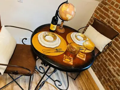 a table with plates and a bottle of wine on it at NYC Cozy Private Bedroom with Free Parking & Near Subway - Business & Tourists in Van Nest