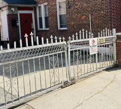 a fence in front of a house with a no parking sign at NYC Cozy Private Bedroom with Free Parking & Near Subway - Business & Tourists in Van Nest