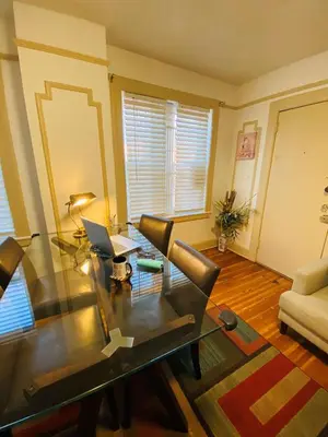 a living room with a glass table and a laptop at NYC Cozy Private Bedroom with Free Parking & Near Subway - Business & Tourists in Van Nest