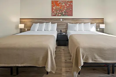 two beds sitting next to each other in a hotel room at Highbridge Hotel in Bronx