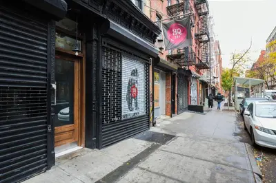 a street with buildings and cars parked on the sidewalk at Nolita 1br w wd nr New Museum NYC-1037 in New York
