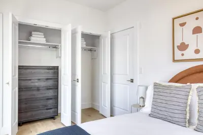 a bedroom with a bed and a closet at Jersey City 2BR w wd roof gym nr Path NYC-962 in Jersey City