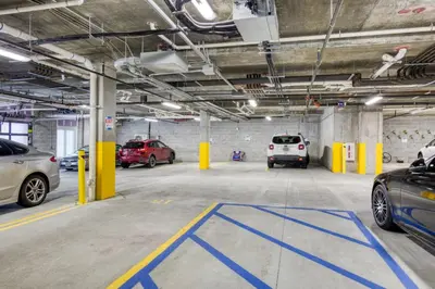 a parking garage with several cars parked in it at Jersey City 2BR w wd roof gym nr Path NYC-962 in Jersey City