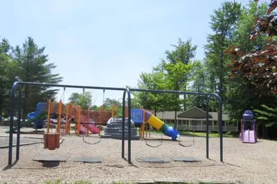 a park with a playground with slides and swings at The Family Getaway in Tobyhanna